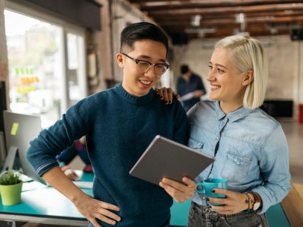 dos jóvenes hablando en el trabajo